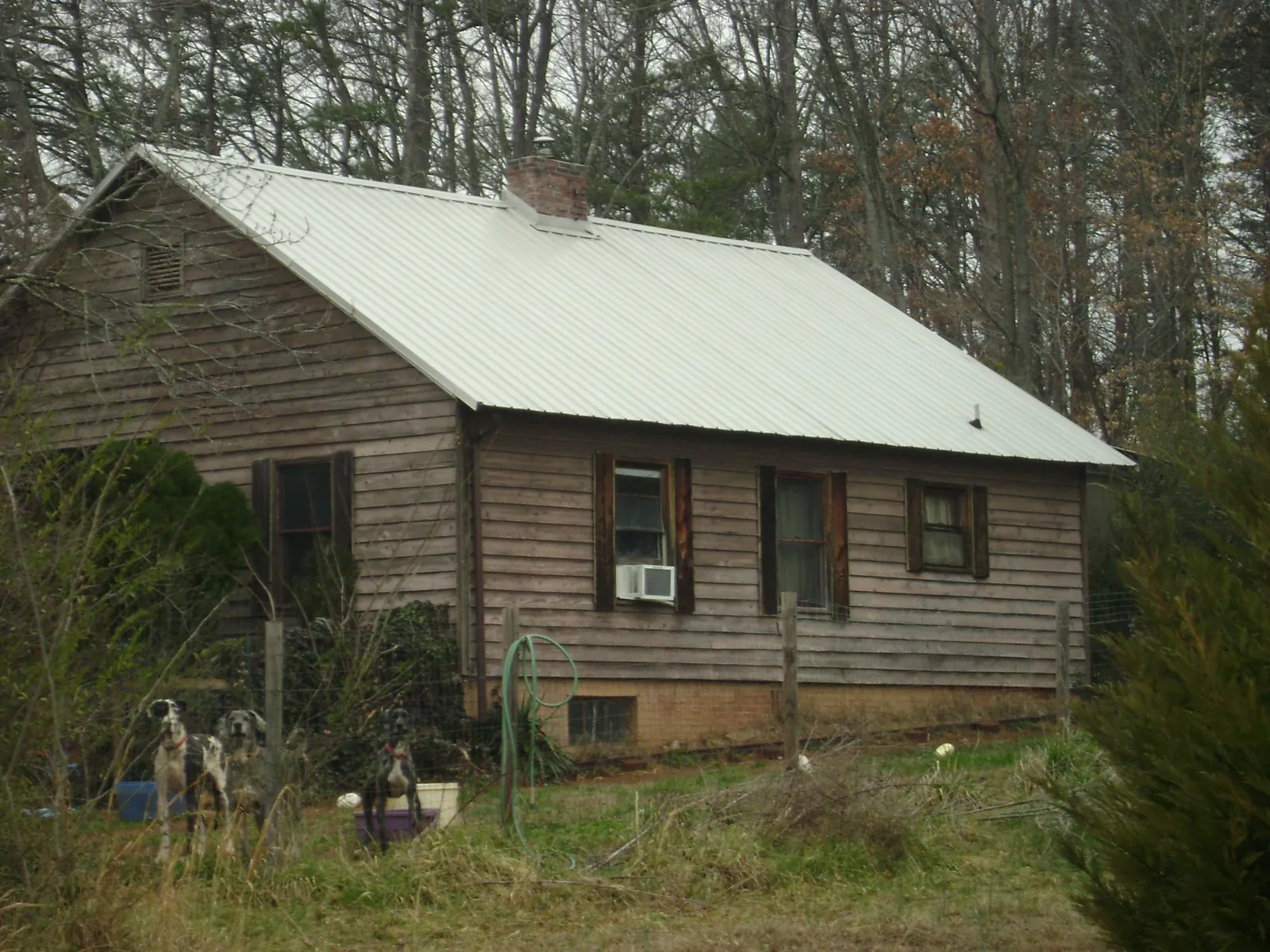 White metal roof on an old wood sided farmhouse, from a Metal Roof Installation job in Fountainville